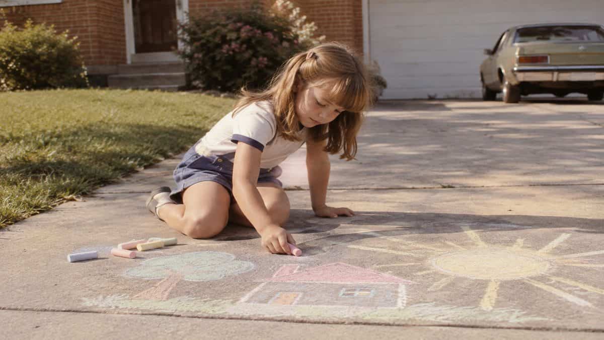 Before Screens: How We Entertained Ourselves 18 Child drawing with sidewalk chalk