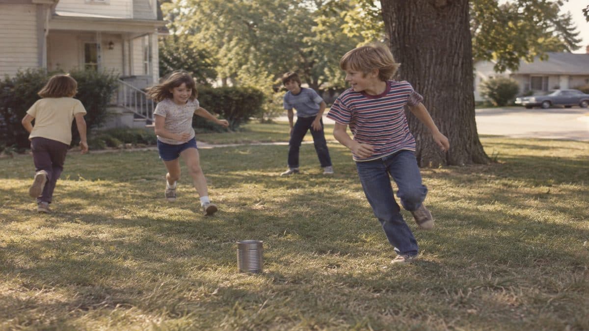 Before Screens: How We Entertained Ourselves 3 Kids playing kick the can outside.