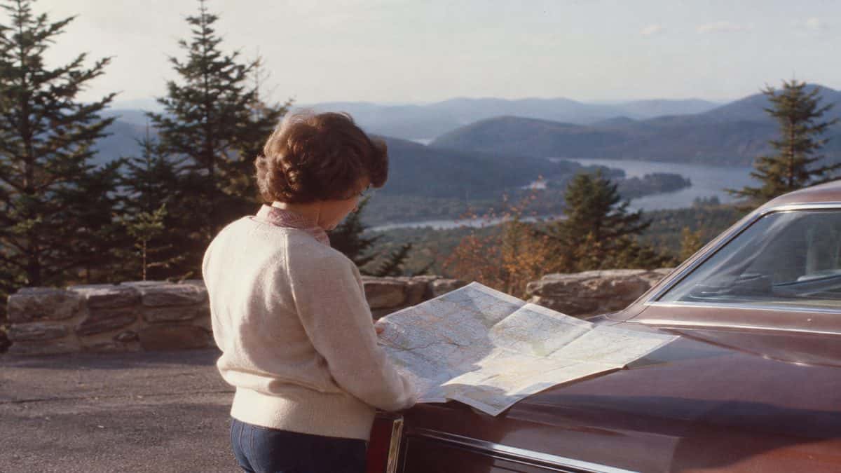 17 Life Skills We Learned Without the Internet That Made Us Smarter 2 Genuine photograph of a person looking at a real paper road map.