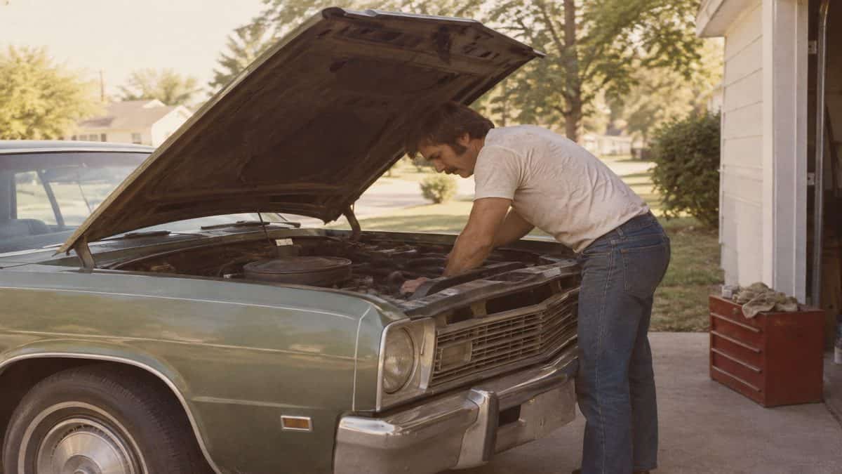 17 Life Skills We Learned Without the Internet That Made Us Smarter 5 Someone working under the hood of a car