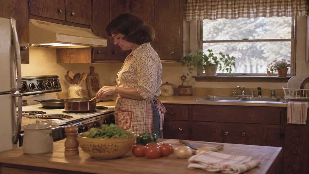 17 Life Skills We Learned Without the Internet That Made Us Smarter 7 Person cooking in a kitchen