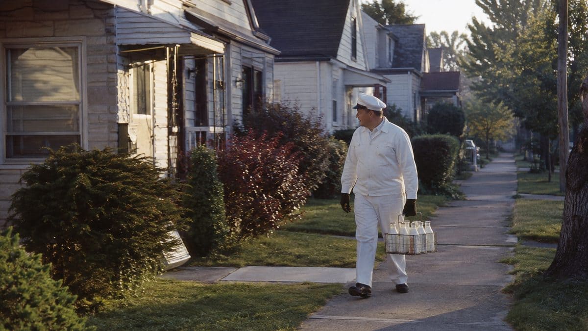 12 Things Every Kid Who Grew Up With a Milkman Remembers 2 Milkman carrying a wire carrier of glass bottles