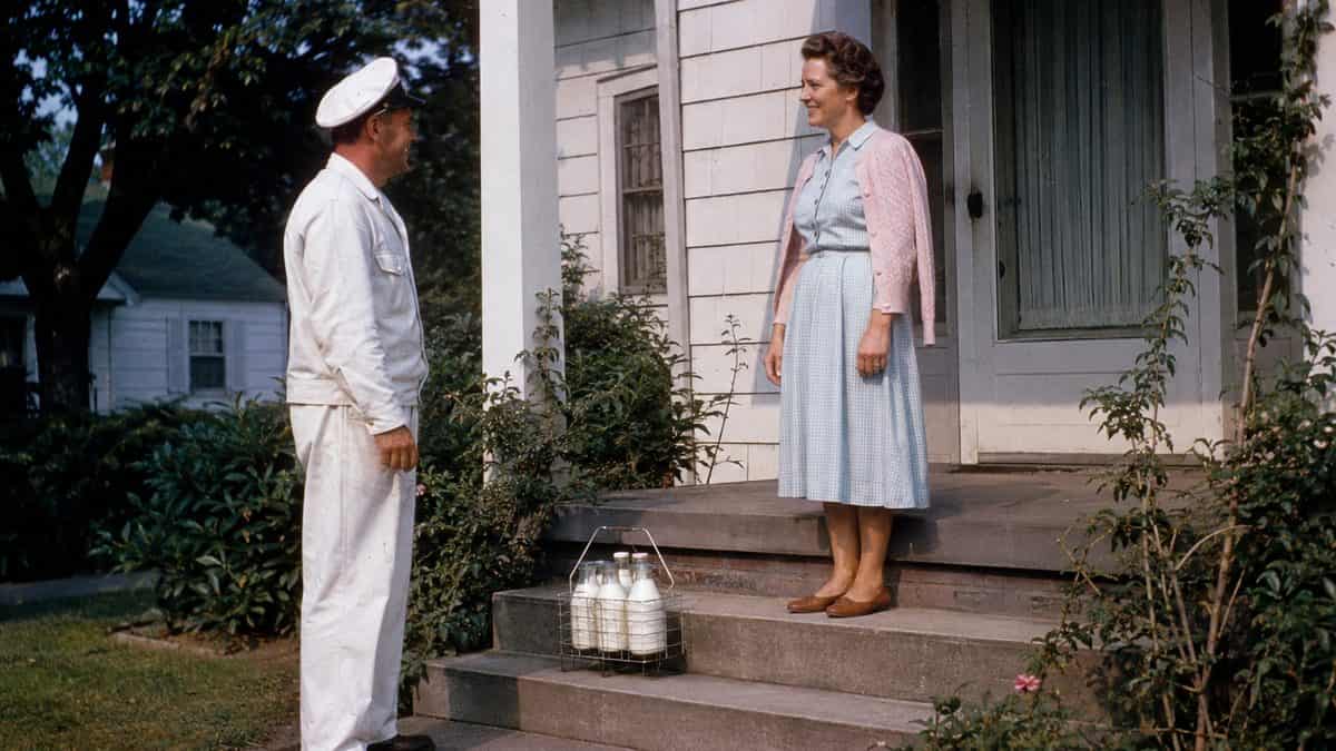 12 Things Every Kid Who Grew Up With a Milkman Remembers 9 Milkman interacting with a customer