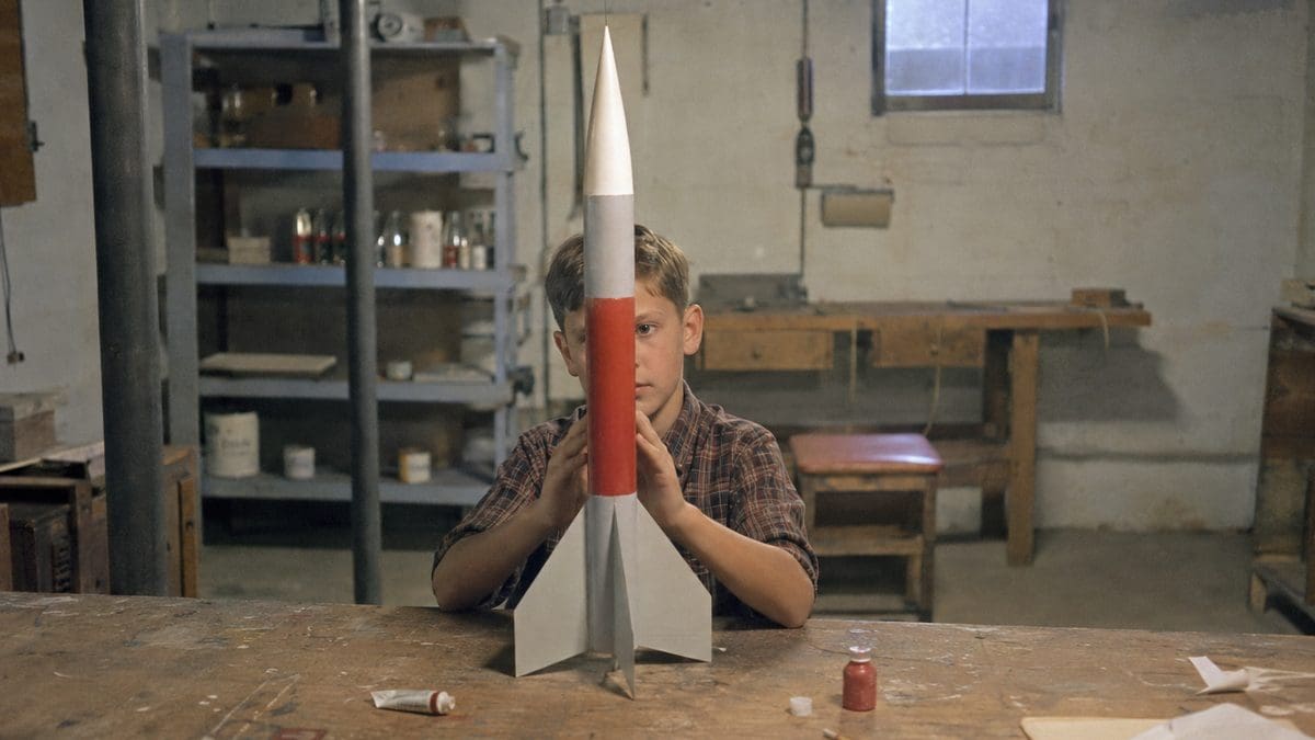 Child building or holding a model rocket
