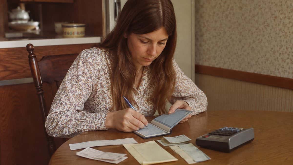 Life Skills Our Generation Mastered That Barely Exist Anymore 5 Person balancing a checkbook in the 1960s or 70s