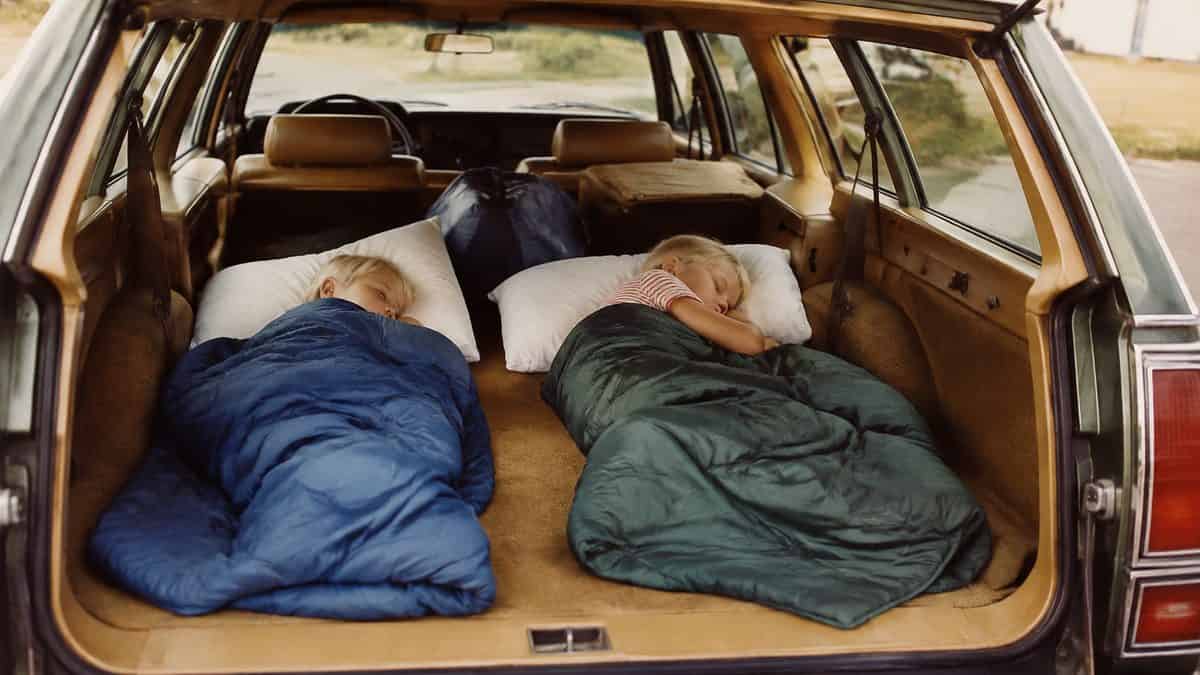 13 Family Road Trip Rituals from the '70s Nobody Does Anymore 12 Real 1970s photo of kids sleeping in the cargo area of a station wagon.
