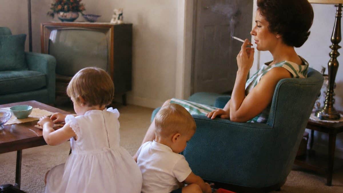 Parenting Practices from the '60s That Were Completely Normal Then 3 Real vintage photo showing a parent smoking near children