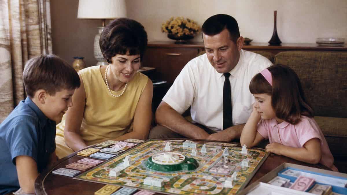 Classic Board Games from the '60s Worth Playing Again 11 Family playing the classic 1960s Game of Life.