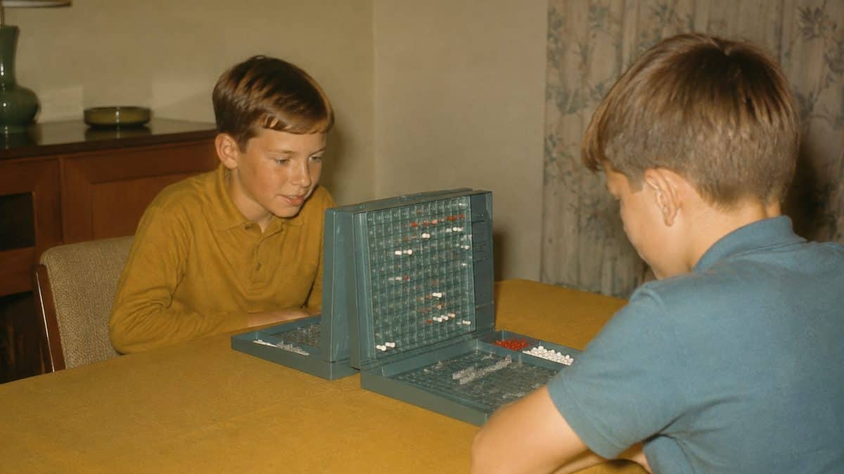 Classic Board Games from the '60s Worth Playing Again 9 Two boys playing a vintage 1960s Battleship game.