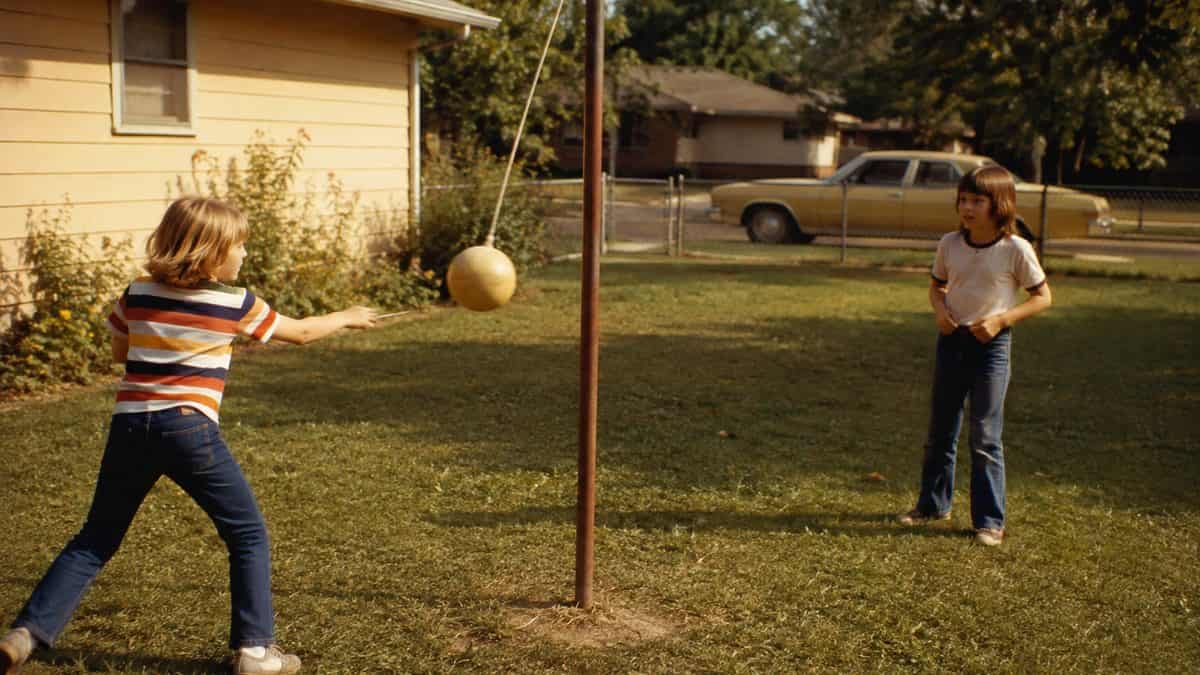 Backyard Games from the '70s That Kept Kids Outside Until Dark 12 Kids playing tetherball