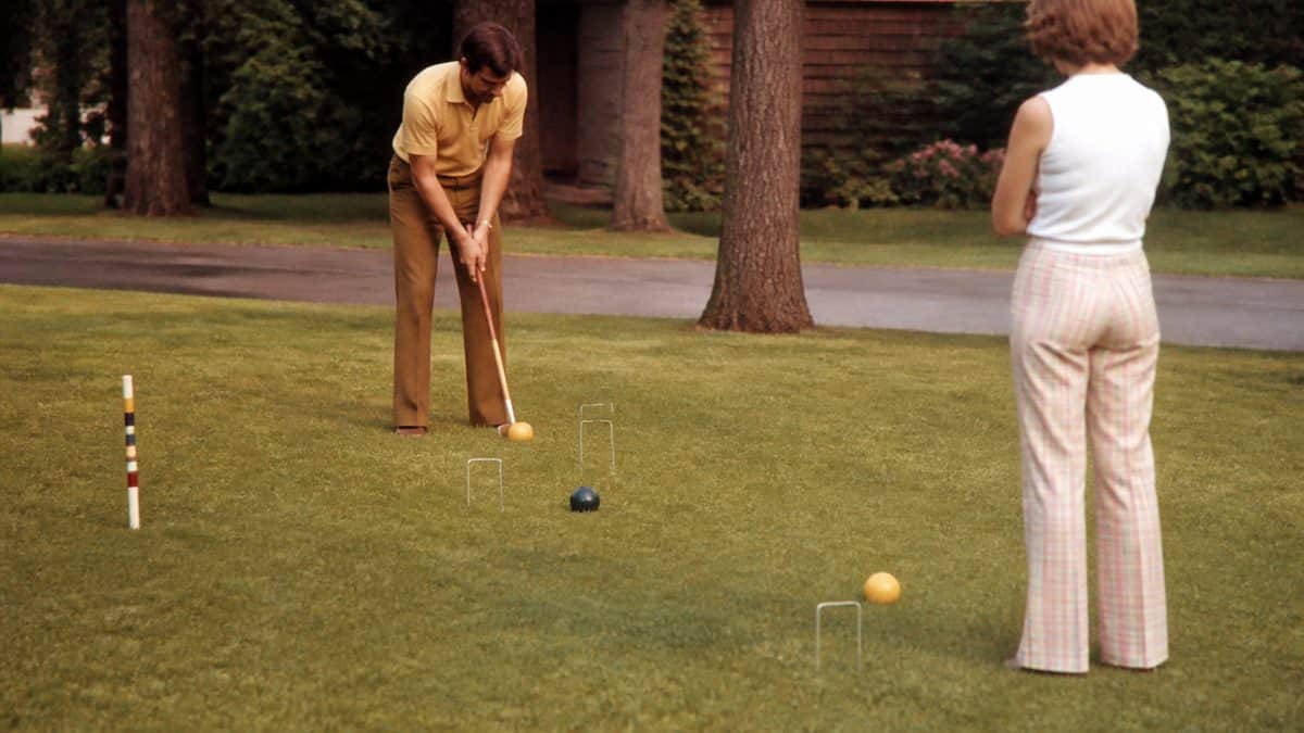 Backyard Games from the '70s That Kept Kids Outside Until Dark 13 Real 1970s photo of a family playing croquet