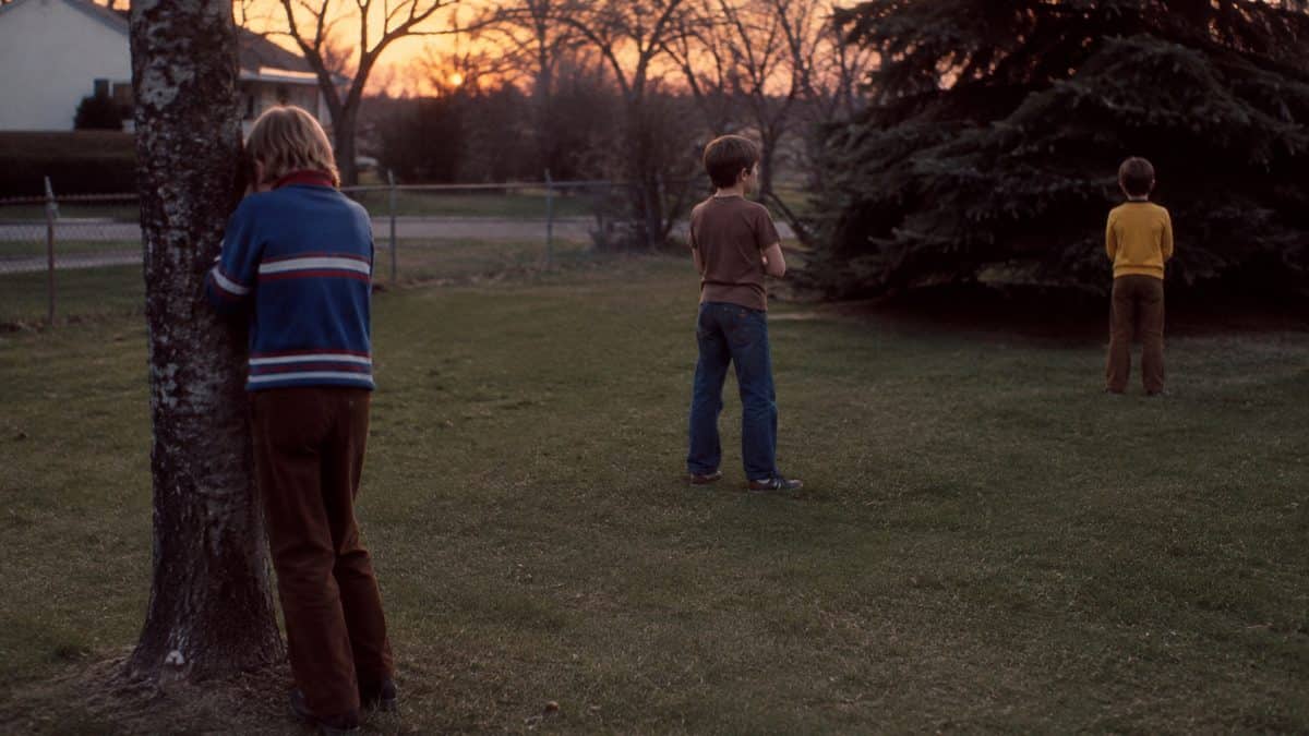 Backyard Games from the '70s That Kept Kids Outside Until Dark 14 Kids playing outdoors at dusk