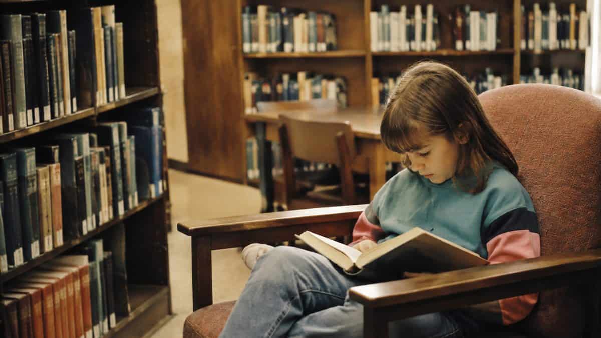Child reading in a library.