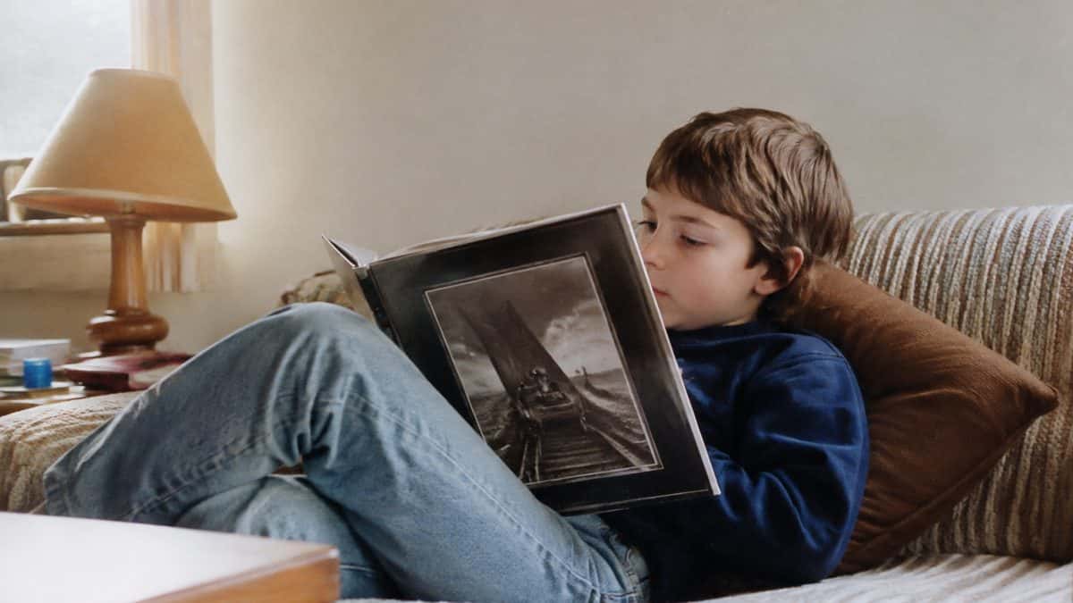 Authentic 1980s photo of a child reading a book.