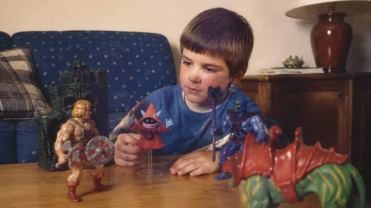 14 Unforgettable '80s Cartoon Characters You Loved 13 Vintage 1980s photo of a child playing with He-Man toys