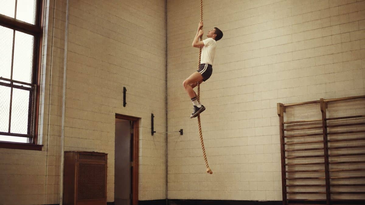 Student climbing a gym rope