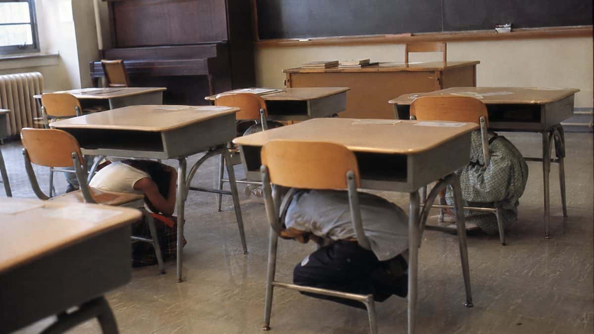 1950s/60s duck and cover drill in a classroom.