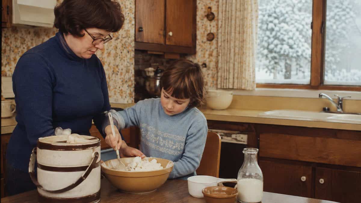 Authentic retro photo of a family making treats in a vintage kitchen