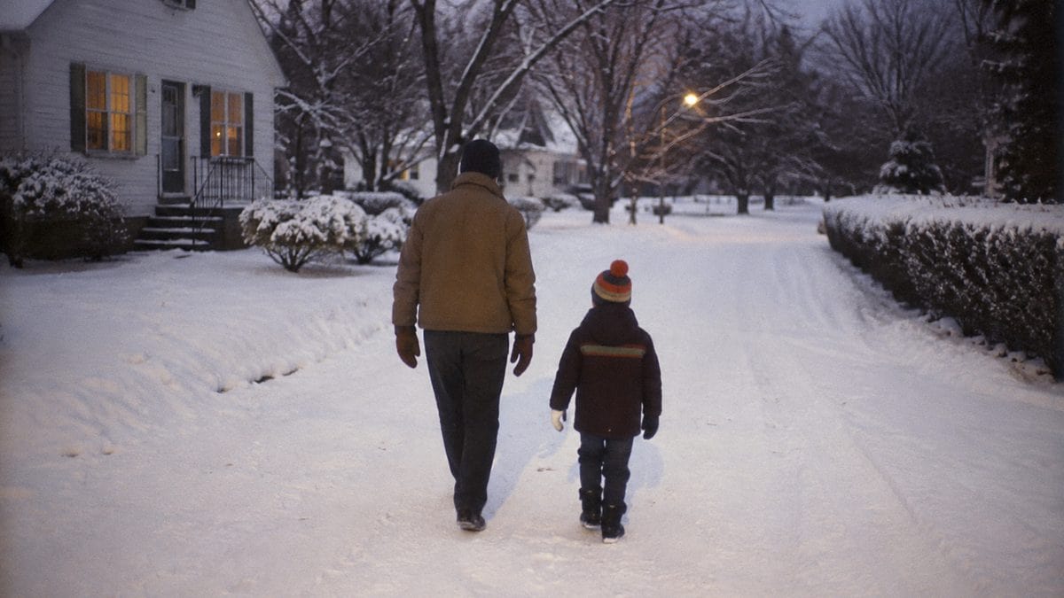 Parent and child walking in snow