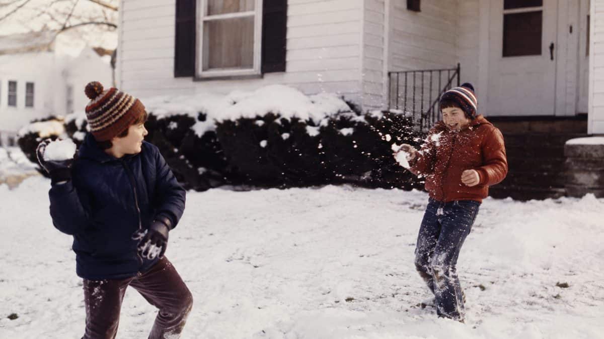 Kids having a snowball fight.