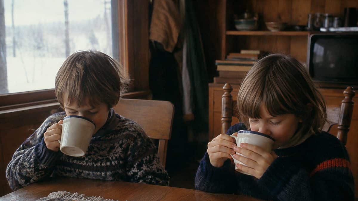 Kids drinking hot chocolate indoors