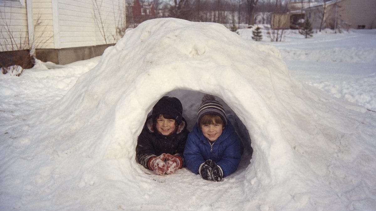 Children playing in a snow fort