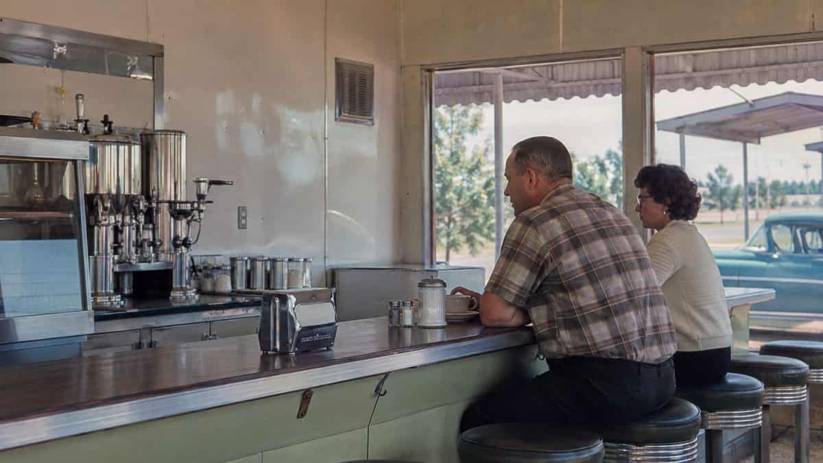 14 Classic Roadside Diners Every '50s Family Stopped At 8 Customers at a diner counter