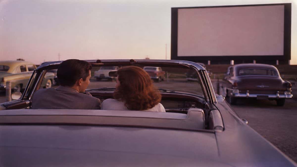Couple in a car at a 1950s drive-in.