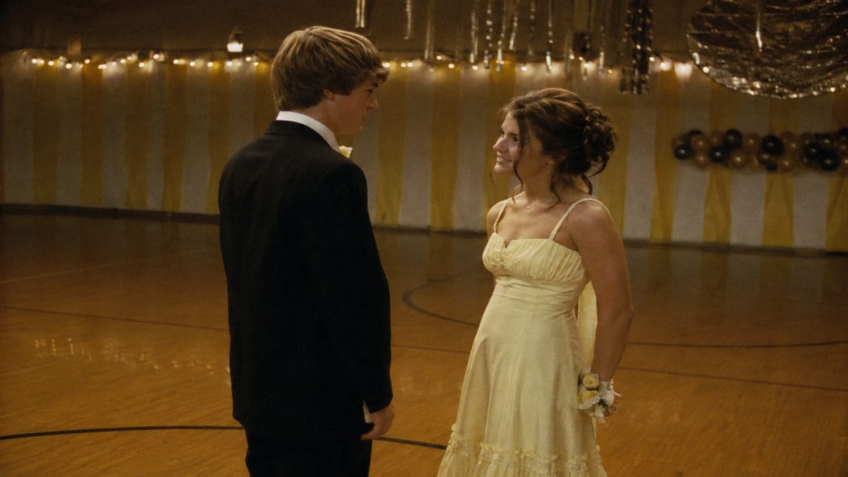 Authentic mid-century photograph of teenagers at a school prom or dance.
