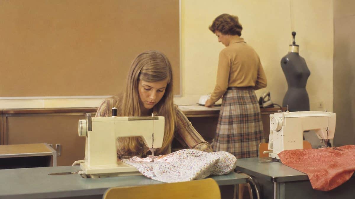 Real 1970s photograph of a home economics sewing class