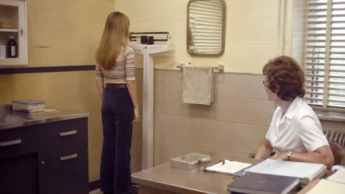 Student at a school nurse's office scale