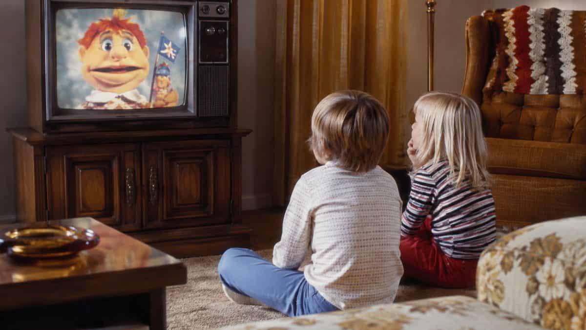 16 Saturday Morning Cartoons That Defined Your Childhood 15 Vintage 1970s photo of kids watching a children's show on TV