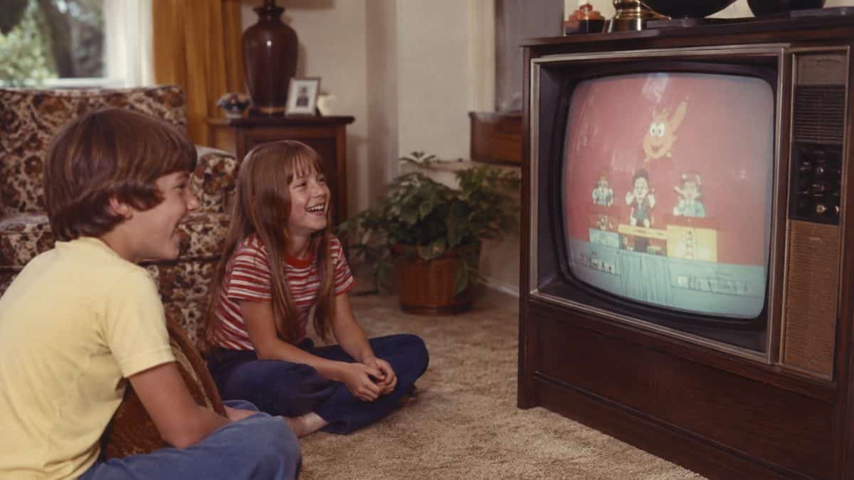16 Saturday Morning Cartoons That Defined Your Childhood 17 Vintage 1970s photo of children laughing while watching television