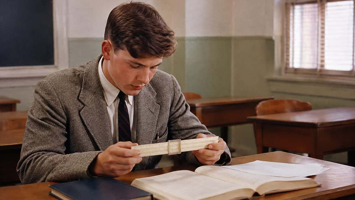 Remember These? 14 School Supplies That Defined the '50s Classroom 3 Student using a slide rule