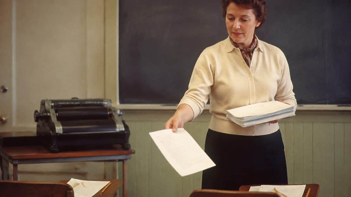 Remember These? 14 School Supplies That Defined the '50s Classroom 9 Teacher handing out mimeograph papers