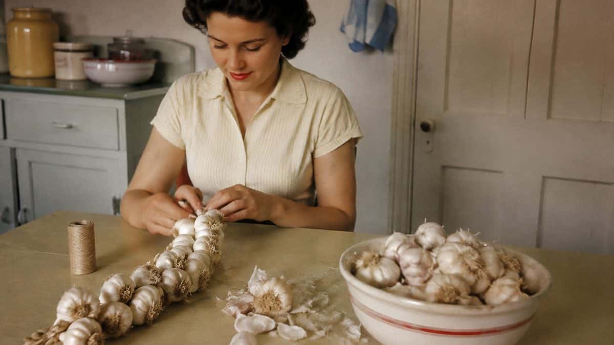 Home Remedies from the '50s Your Grandma Swore By 11 Someone making a garlic necklace or a still life of garlic cloves