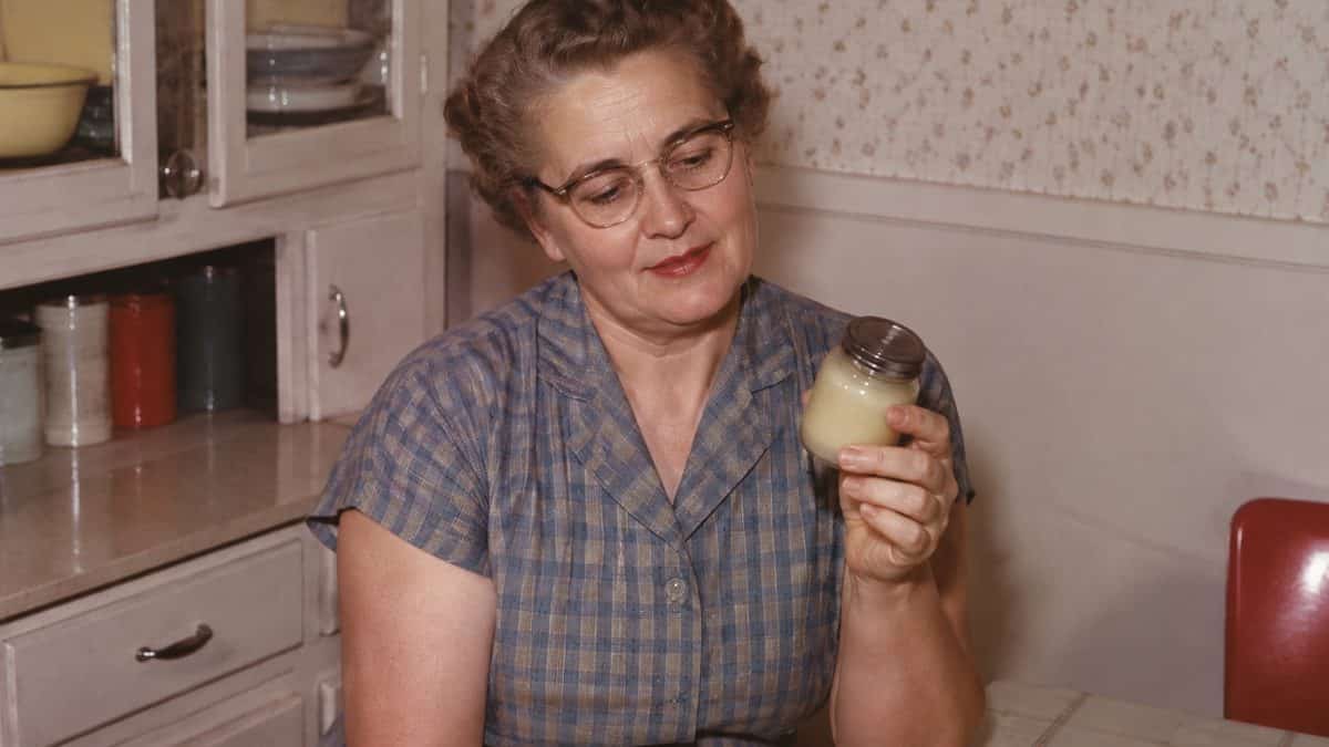 Home Remedies from the '50s Your Grandma Swore By 12 Grandmother holding a jar of ointment