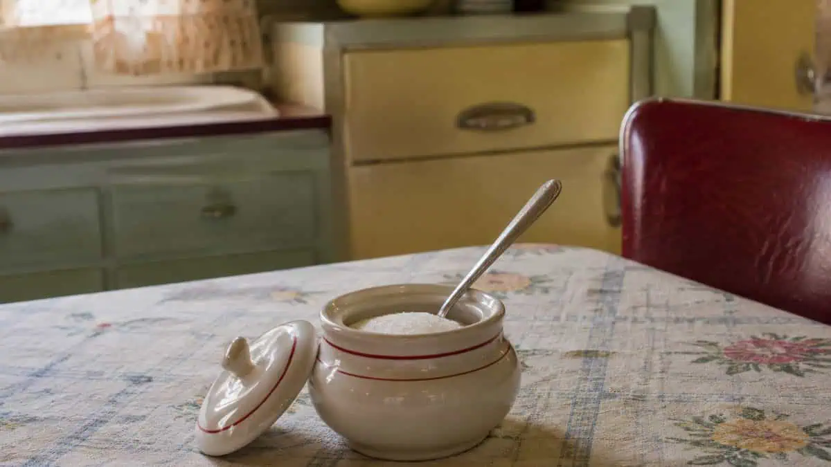 Home Remedies from the '50s Your Grandma Swore By 13 Sugar bowl and spoon on a 1950s kitchen table