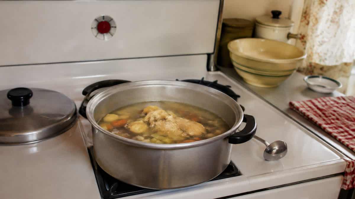 Home Remedies from the '50s Your Grandma Swore By 9 Homemade chicken soup cooking on a stove