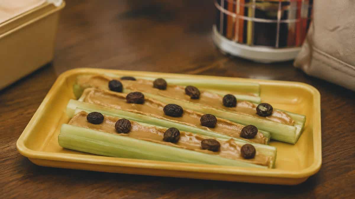 Natural, authentic photo of celery with peanut butter and raisins
