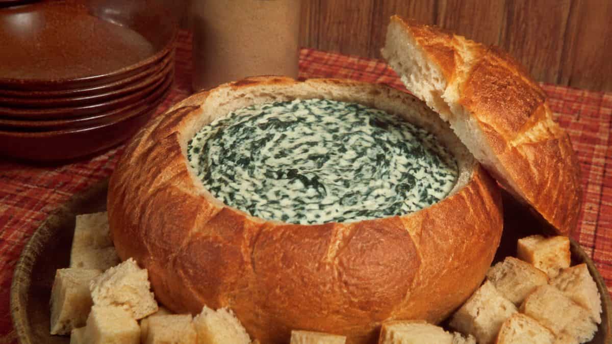 13 Party Foods from the Seventies That Should Make a Comeback 14 Real photograph of a spinach dip bread bowl from a 1970s recipe book.