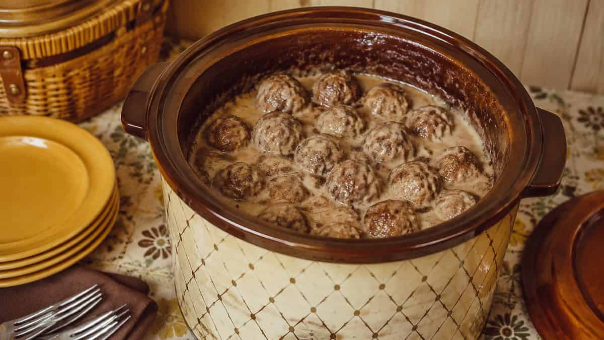 13 Party Foods from the Seventies That Should Make a Comeback 4 Authentic close-up of Swedish meatballs in a real 1970s Crock-Pot