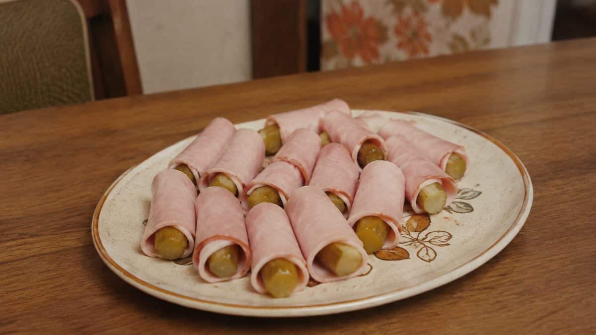 13 Party Foods from the Seventies That Should Make a Comeback 10 Ham and pickle roll-ups on a vintage plate