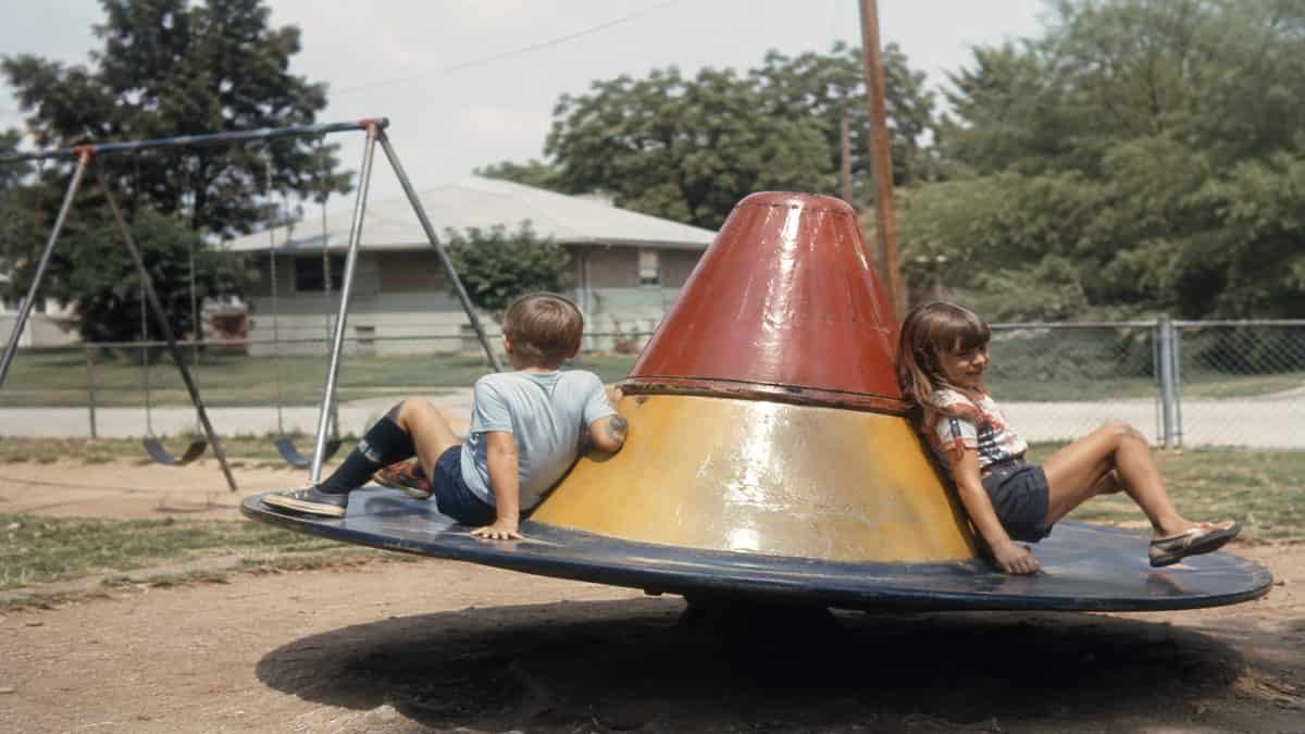 Remember These? 15 Playground Equipment Pieces That Would Never Pass Safety Standards Today 3 Kids on a Witch's Hat spinner.
