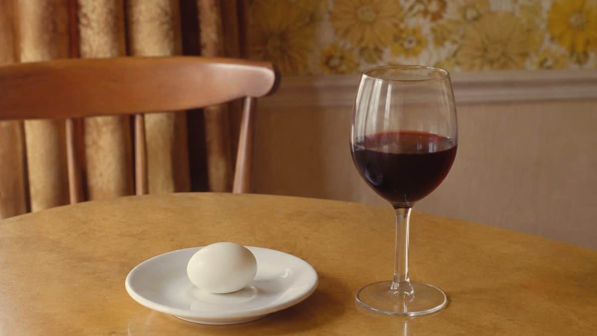 Authentic 1970s photo of a hardboiled egg and a glass of wine.
