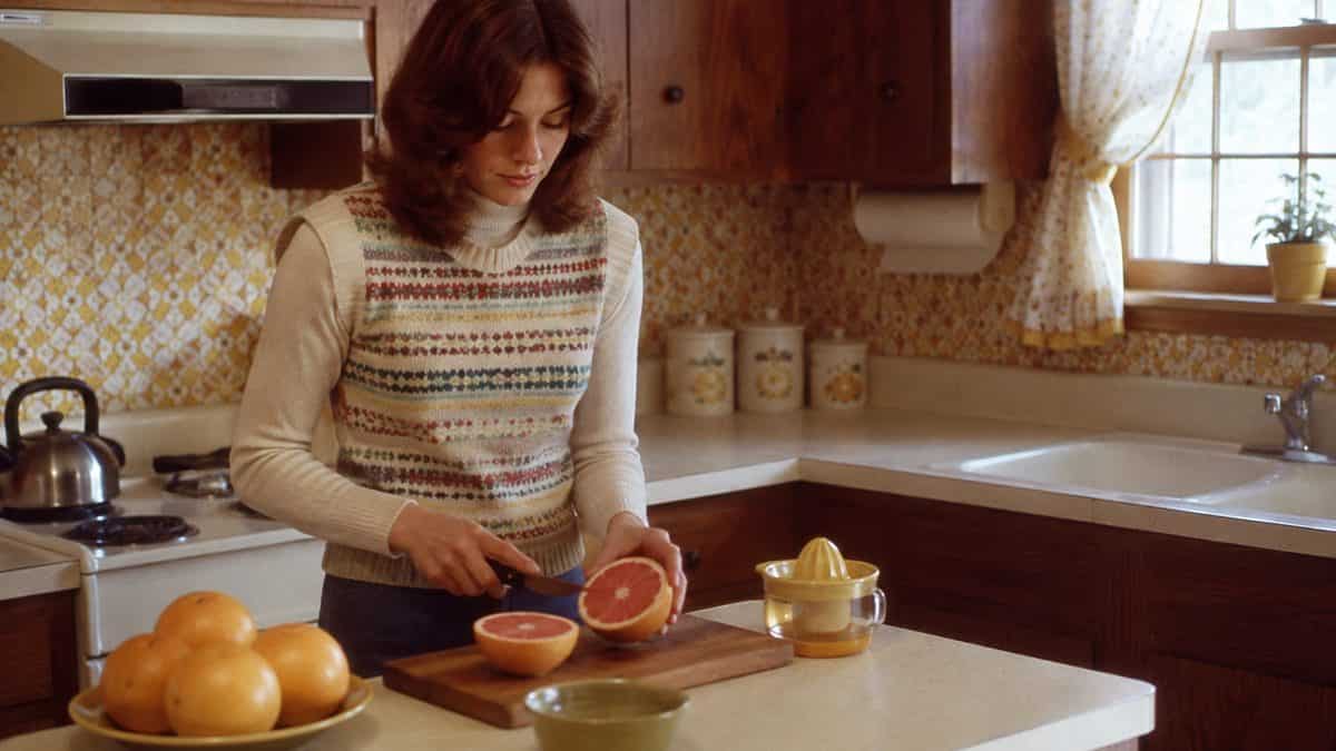 Someone preparing grapefruit in a kitchen