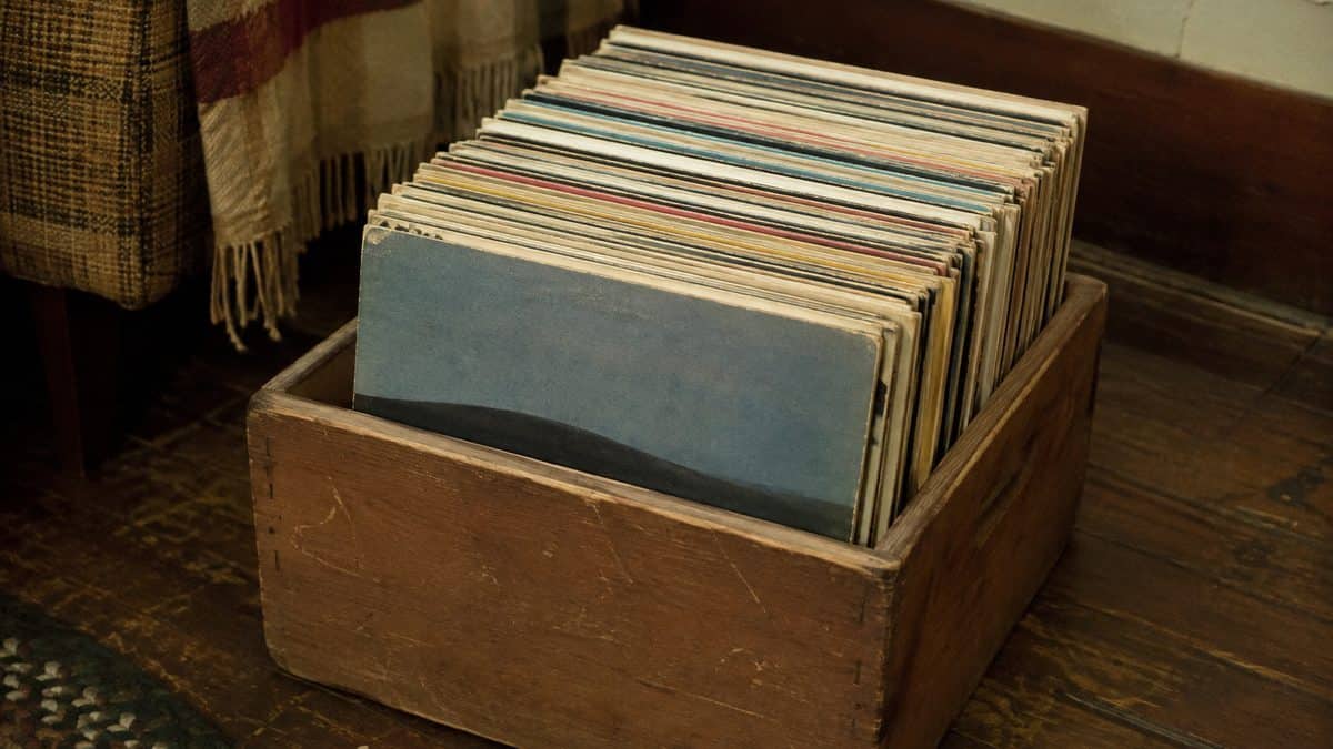 Crate of vintage vinyl records showing individual sleeves