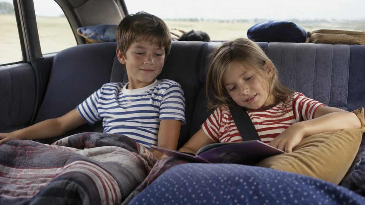 Siblings sharing the backseat peacefully