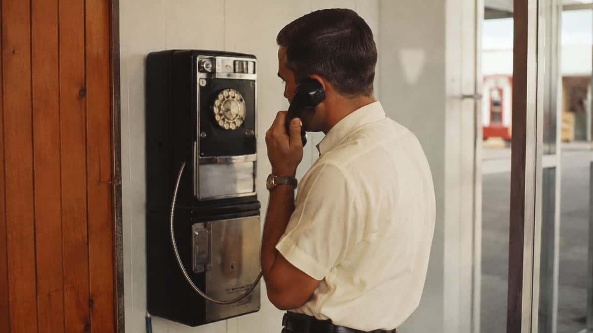 13 Things You Could Buy for a Dollar in the '60s 8 Someone using a 1960s payphone.