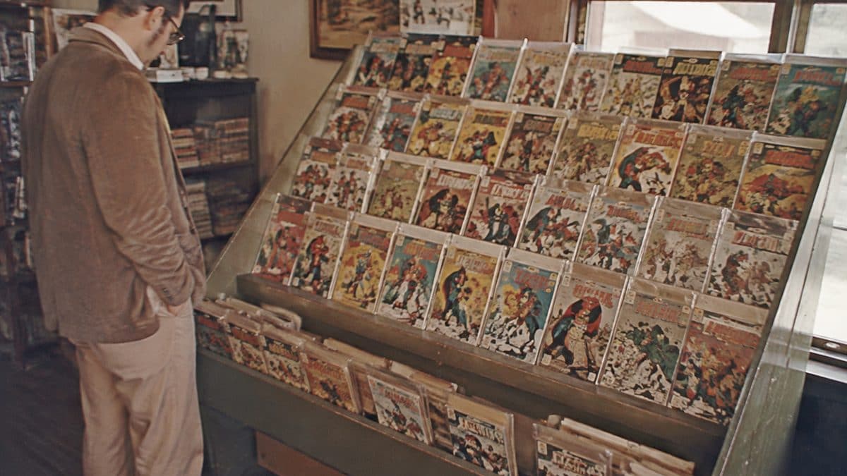 Household Items Every Family Owned That Are Worth a Fortune Now 8 Vintage comic books on a stand.